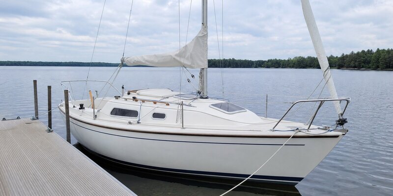 A white Capri 22 tied alongside the rental dock